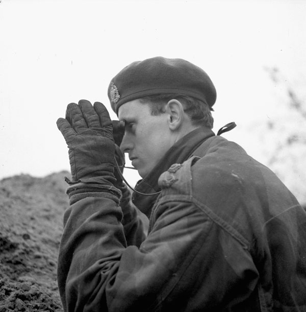 Lieutenant Louis Woods of Le Régiment de Maisonneuve observing a German position during Operation VERITABLE near Nijmegen, Netherlands, 8 February 1945.