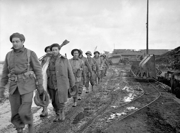 Infantrymen of Le Régiment de la Chaudière marching along a dike near Nijmegen, Netherlands, 10 February 1945.