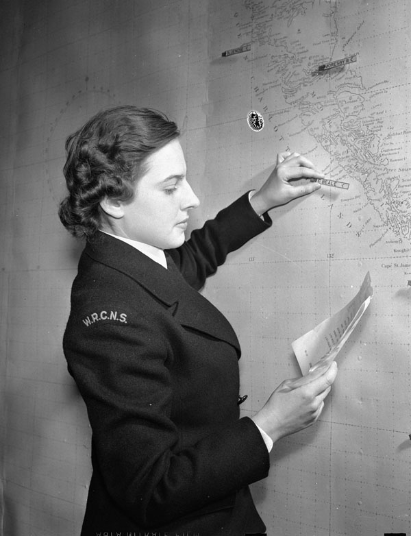 An unidentified member of the Women's Royal Canadian Naval service (W.R.C.N.S.) plotting shipping movements on a chart, Ottawa, Ontario, Canada, January 1943.