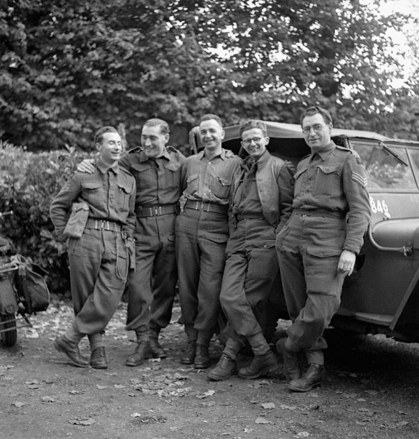 Sergeant L.F. Millon of the Canadian Army Film and Photo Unit with a group of British Army photographers, Bruges, Belgium, 29 October 1944.
