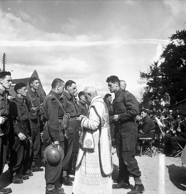 Infantrymen of Le Régiment de Maisonneuve attending a Mass celebrating Bastille Day, Rots, France, 13 July 1944.