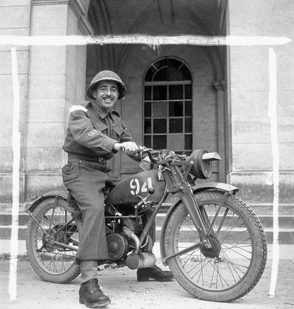 Brigade Sergeant-Major R.M. Cooper of the 9th Canadian Infantry Brigade, who rides a Norton WD16H motorcycle, Carpiquet, France, 12 July 1944.