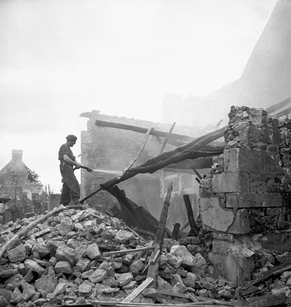Personnel of the Royal Canadian Engineers (R.C.E.) extinguishing a fire caused by German shelling, Carpiquet, France, 12 July 1944.