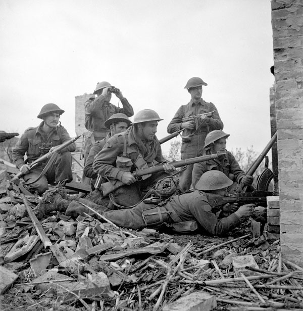 Lieutenant I. Macdonald (with binoculars) of The 48th Highlanders of Canada preparing to give the order to attack to infantrymen of his platoon, San Leonardo di Ortona, Italy, 10 December 1943.