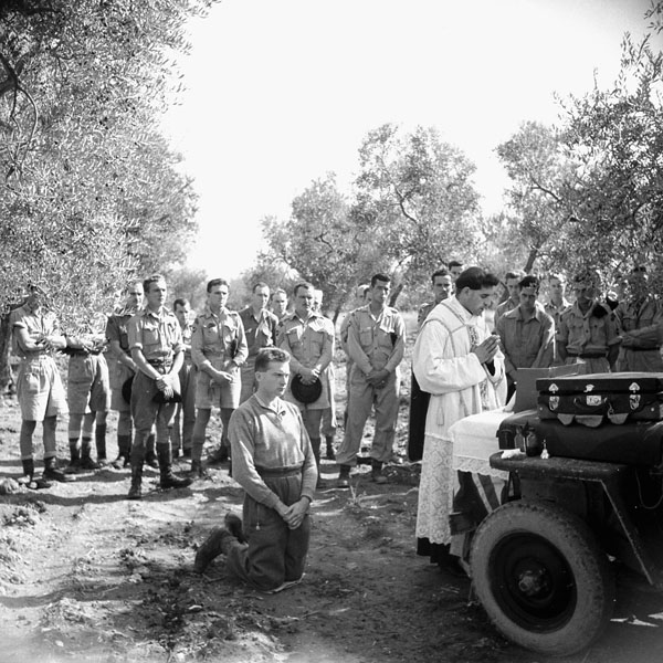 Personnel of the Three Rivers Regiment attend mass being celebrated by an Italian priest who had previously served as a chaplain in the Italian Army, Termoli, Italy, 11 October 1943.