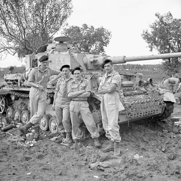 Tank crew of the Three Rivers Regiment with a knocked-out German PzKpfW IV tank, Termoli, Italy, 9 October 1943.