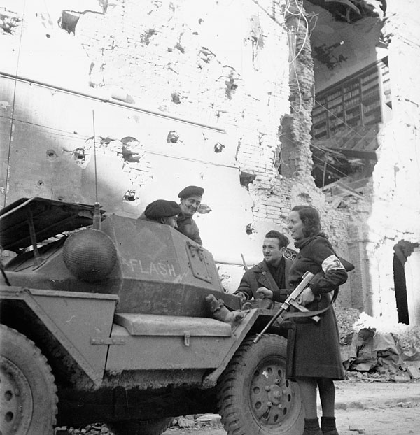 Troopers W. Balinnan and A. Gallant of a Canadian reconnaissance regiment speaking to partisans Louisa and Italo Cristofori after the capture of Bagnacavallo, Italy, 3 January 1945.