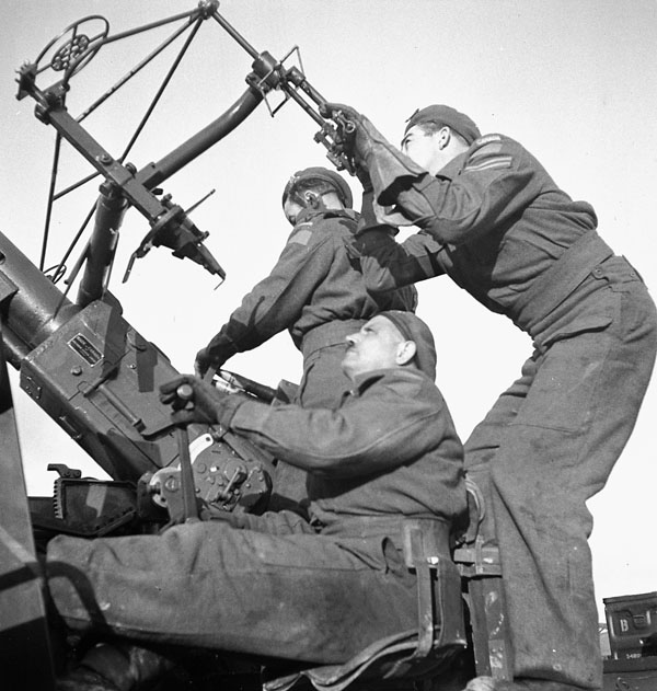 Gunners of the Royal Artillery (British Army) with a Bofors anti-aircraft gun mounted on a Canadian-made Ford chassis, Russi, Italy, 18 February 1945.