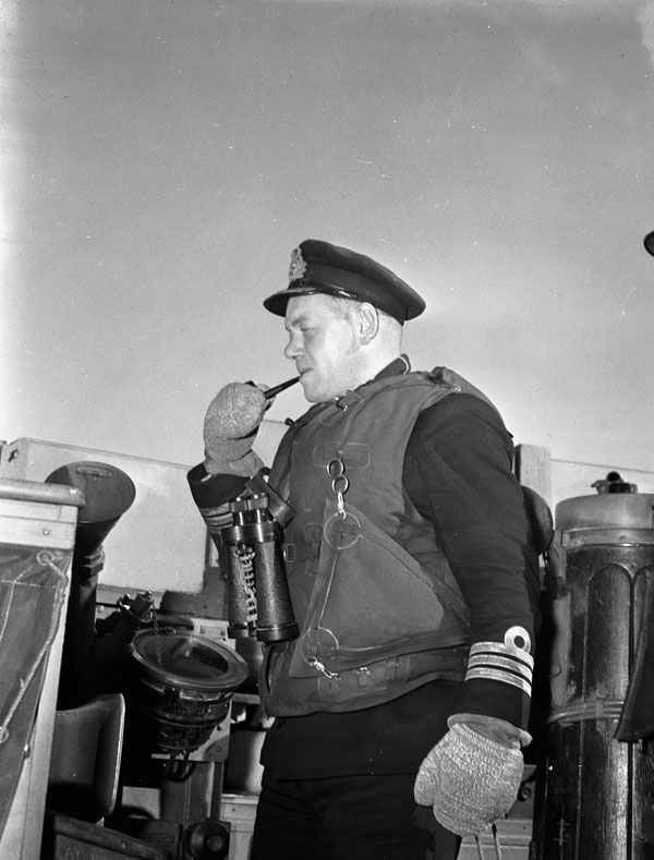Commander Hugh F. Pullen, Commanding Officer,  on the bridge of H.M.C.S. OTTAWA at sea, 22 November 1943.