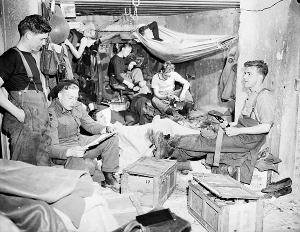 Personnel of the Royal Canadian Navy Beach Commando “W” in their quarters in the Juno sector of the Normandy beachhead, France, 20 July 1944.