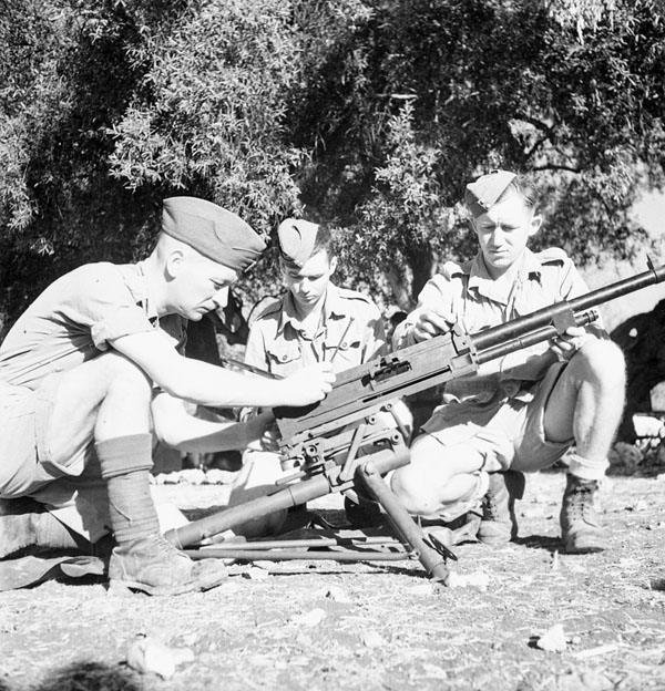 Personnel restoring a captured Italian Breda machine gun, No.1 Canadian Brigade Reinforcement Depot, near Syracuse, Italy, 11 August 1943.