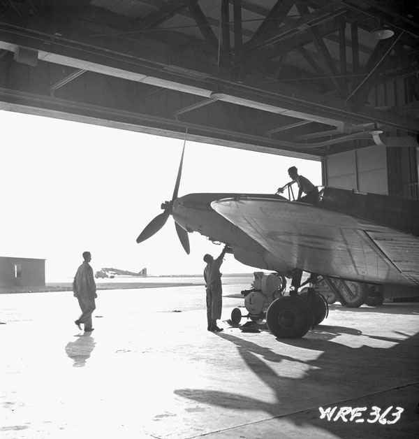 Groundcrew with a Fairey Battle I aircraft in a hangar at No.1 Bombing and Gunnery School (Royal Canadian Airforce Schools and Training Units), Royal Canadian Air Force (R.C.A.F.), Jarvis, Ontario, Canada, July 1941.