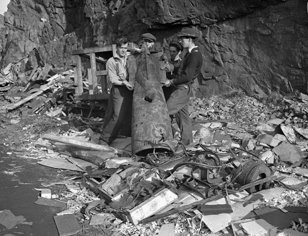 Damage to the Scotia Pier caused by a torpedo fired by the German submarine U-518 on 2 November 1942. Bell Island, Newfoundland, 3 November 1942.
