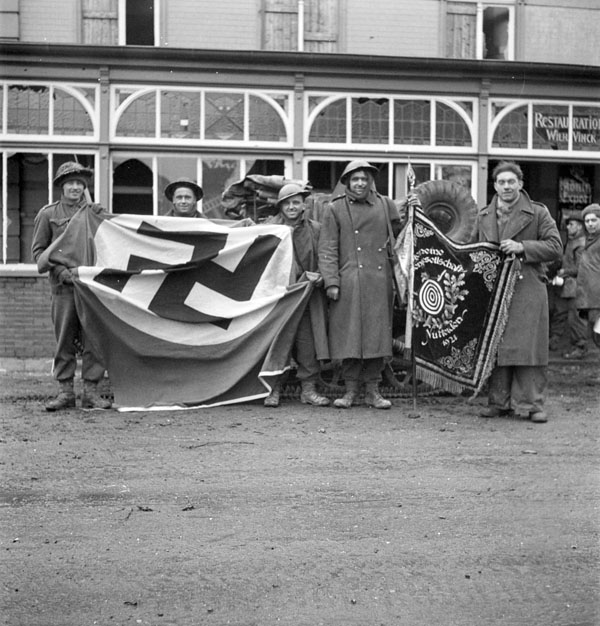 British soldiers with captured German flags, Kranenburg, Germany, 9 February 1945.