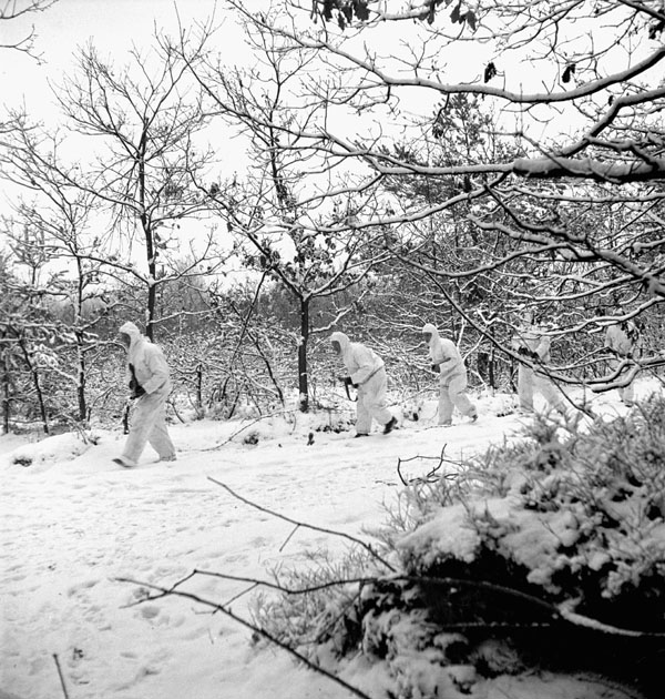 Infantrymen of the Queen's Own Rifles of Canada, who are wearing British snow camouflage clothing, on a night patrol near Nijmegen, Netherlands, 2 January 1945.