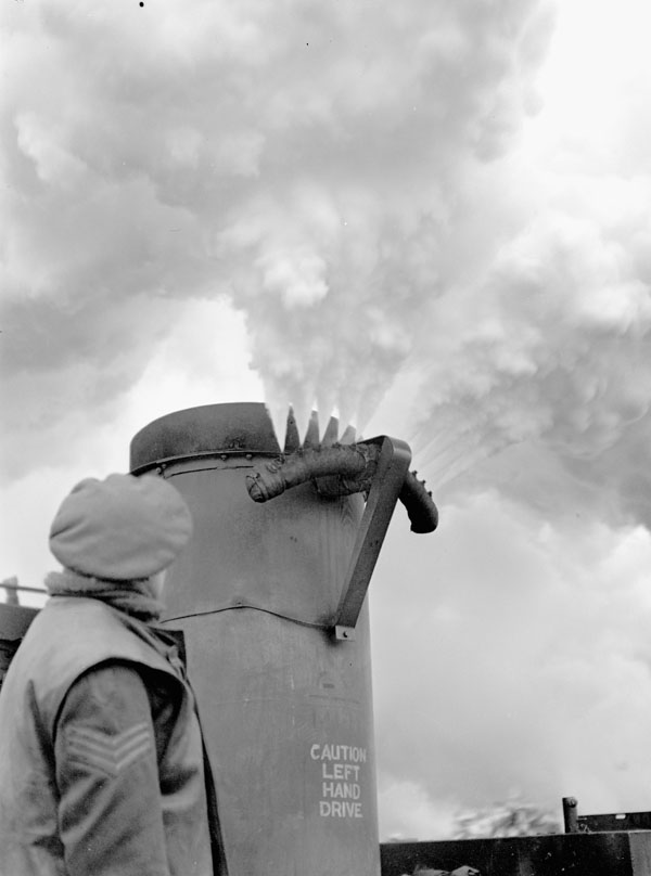 A smoke generator laying a smokescreen to hide the movements of the 3rd Canadian Infantry Division during Operation VERITABLE, Wyler, Germany, 15 February 1945.