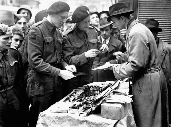 Troopers of the Governor General's Horse Guards at an outdoor shop on the Via Roma, Naples, Italy, 27 November 1943.