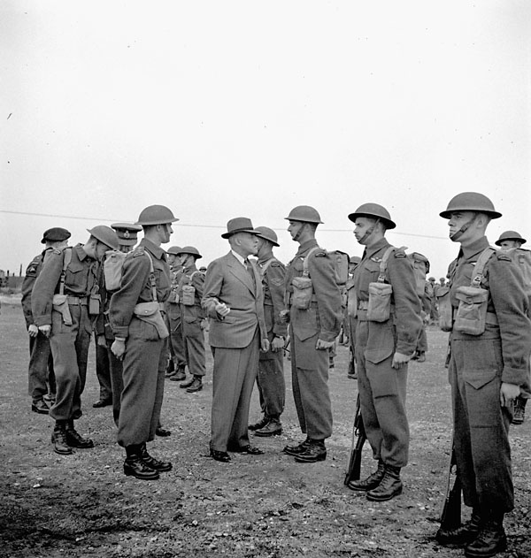 Colonel the Honourable J.L. Ralston, Minister of National Defence, inspecting paratroopers of the 1st Canadian Parachute Battalion, Chobham, England, 3 August 1943.