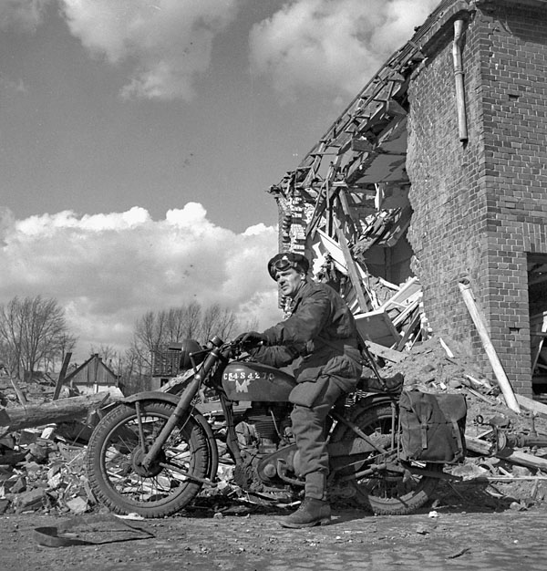 Lieutenant G. Murray Williams of Headquarters Company, 1st Canadian Parachute Battalion, riding a Norton Model 1G-H motorcycle during the battalion's advance from Lembeck through Coesfeld, Germany, 30 March 1945.