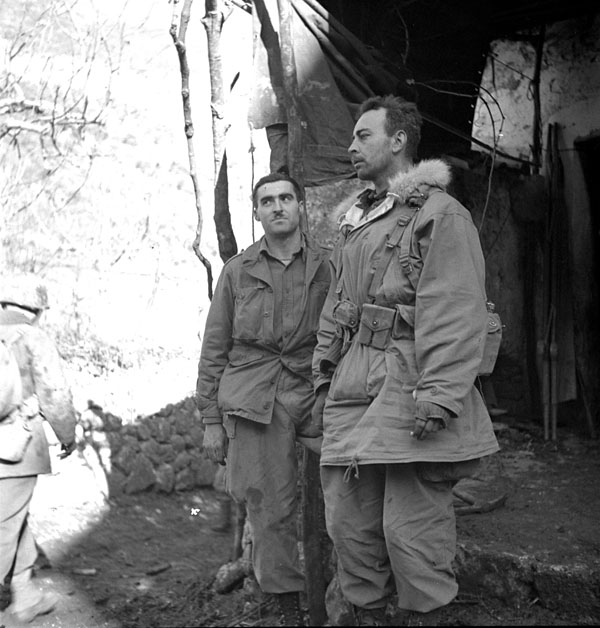 Lieutenant J. Kostelec of Calgary, Alberta, Canada, and Lieutenant H.C. Wilson of Olympia, Washington, United States, both officers of the First Special Service Force, standing outside a clearing station at Noci, near the Force's next objective, Radicoso, Italy, 2 January 1944.