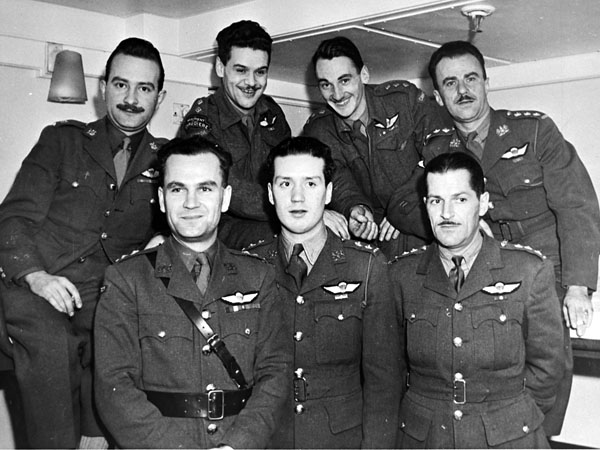 Seven repatriated parachute-qualified Canadian officers, who took part in Special Operations Executive (S.O.E.) missions prior to and following D-Day, on a troopship arriving at Halifax, Nova Scotia, Canada, 20 December 1944.